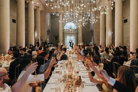 Banquet hall with guests raising glasses