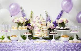 Dessert table with colorful cakes and floral décor